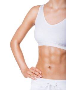 a woman showing her stomach after a tummy tuck